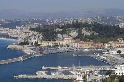 High angle view of sea by buildings in city