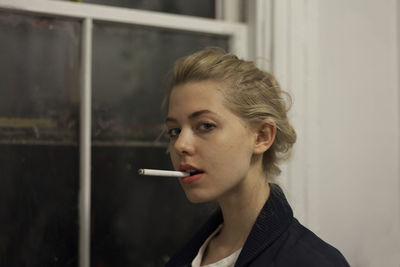 Young woman posing with a cigarette