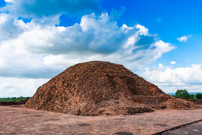 Scenic view of rocks on field against sky