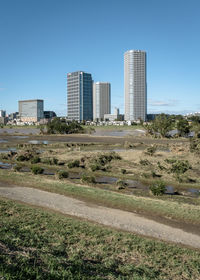 Modern buildings in city against clear blue sky