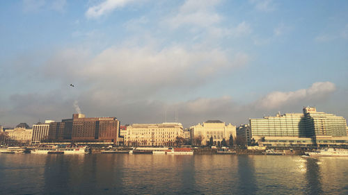 Danube river and buildings against sky in city