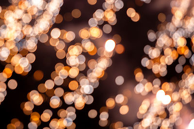 Defocused image of illuminated christmas lights at night