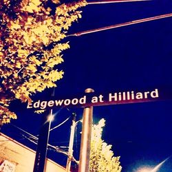 Low angle view of illuminated sign at night