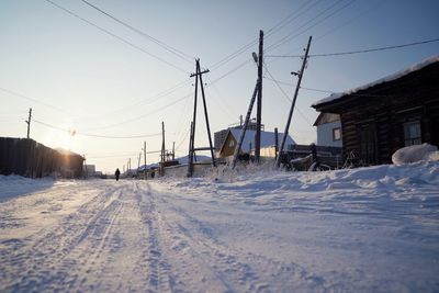 Snow covered buildings against sky