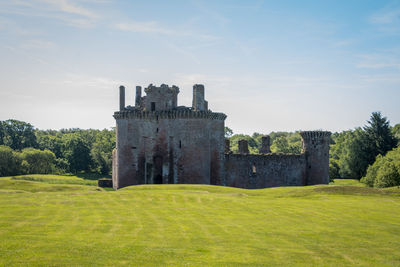 Castle on field against sky