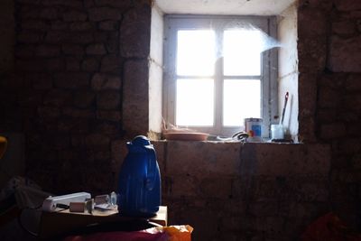 Blue jug on table by window in building