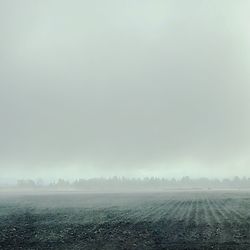 Scenic view of field against sky during winter