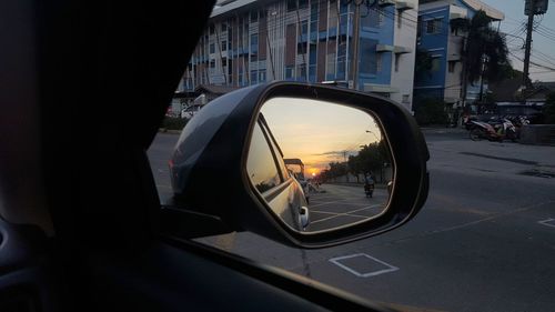 Reflection of road in side-view mirror of car