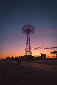 Silhouette ferris wheel against sky during sunset