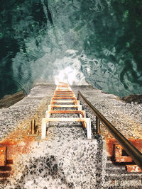 High angle view of staircase by swimming pool