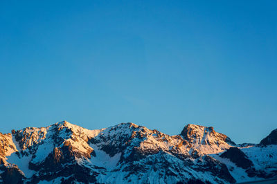 Scenic view of mountains against clear blue sky