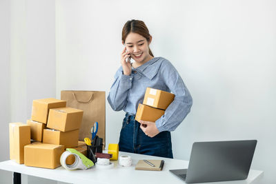 Portrait of young woman using laptop on table