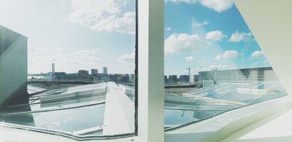 Panoramic view of city seen through glass window