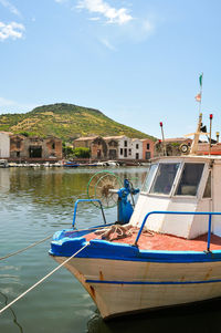 Boats moored on sea against blue sky