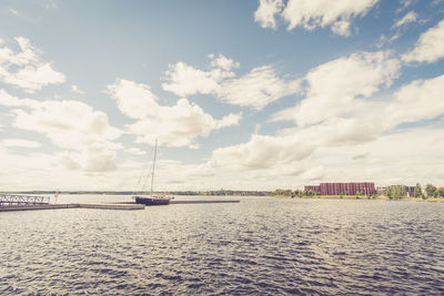 Boat moored at sea against sky