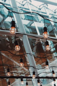 Low angle view of light bulbs hanging from ceiling