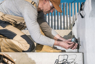 Low section of man working at beach