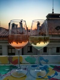 Close-up of beer glass on table against sky