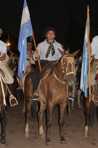 Young man with horses in a market