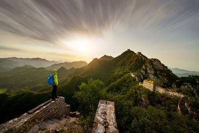 Man standing on mountain against sky