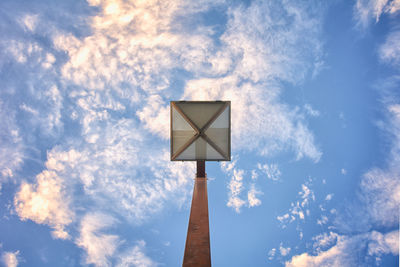 Low angle view of street light against cloudy sky