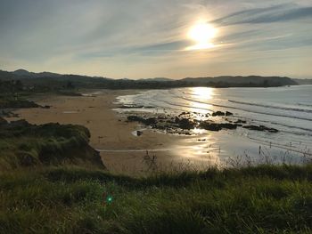 Scenic view of beach against sky during sunset