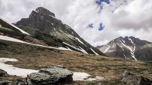 Scenic view of mountains against cloudy sky