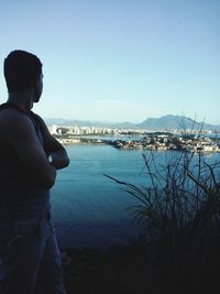 Man standing by sea against clear sky