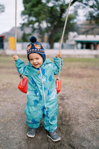 Full length of boy standing on field