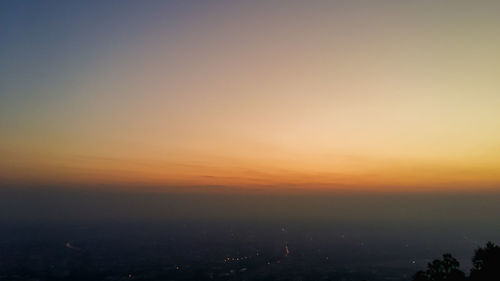 Silhouette cityscape against sky during sunset