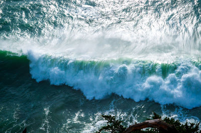 Waves breaking against sea