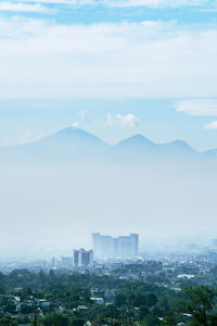 High angle view of buildings in city against sky