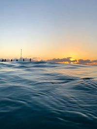 Scenic view of sea against clear sky during sunset