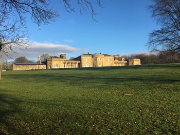 Houses on field against sky