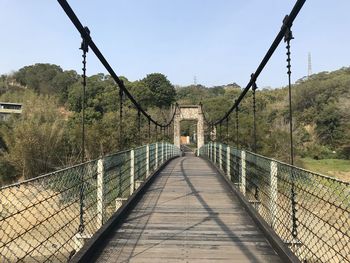 Footbridge against clear sky