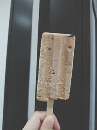 Close-up of hand holding ice cream