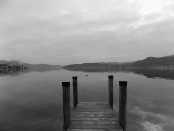 Pier over lake against sky