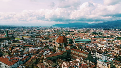 Cityscape against cloudy sky