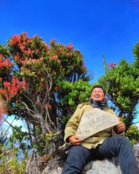 Portrait of man sitting on field