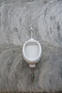 Close-up of urinal against wall