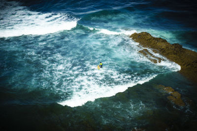 High angle view of man surfing in sea