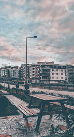 Buildings in city against cloudy sky