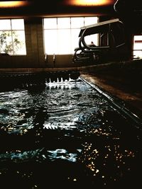 Reflection of silhouette building on swimming pool