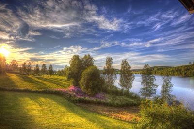 Scenic view of river against cloudy sky