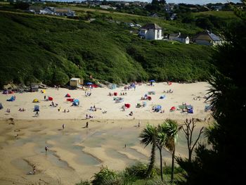 High angle view of crowd at beach during sunny day