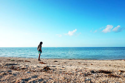 Man standing on beach against sky