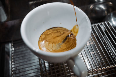 Latte art coffee on wooden table in coffee shop