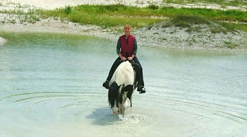 Man riding horse in river