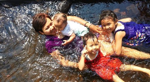 Portrait of siblings playing with sister