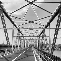 Low angle view of suspension bridge against sky